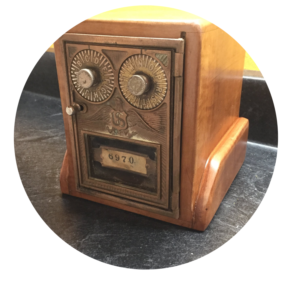 a wooden box with a post office box door.